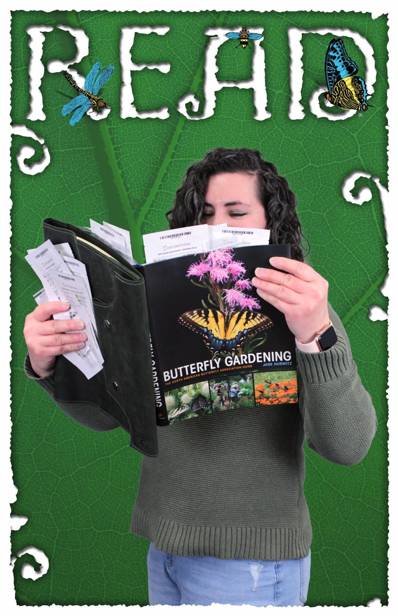 Librarian holding the book "Butterfly Garden" along with a lot of seed packets, with "READ" at the top